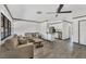 The living room features neutral walls, gray floors, a ceiling fan and furniture set at 11 Quails Run Blvd # 9, Englewood, FL 34223