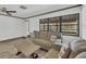 Cozy living room featuring hardwood floors, comfortable seating, and natural light at 11 Quails Run Blvd # 9, Englewood, FL 34223