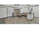 Spacious living room boasts plank floors, comfortable seating, and ample natural light from the window at 11 Quails Run Blvd # 9, Englewood, FL 34223