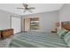 Cozy bedroom features plank flooring, a large glass door, and double closet at 11 Quails Run Blvd # 9, Englewood, FL 34223