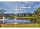 Enjoy views of the picturesque pond from screened in porch at 11 Quails Run Blvd # 9, Englewood, FL 34223