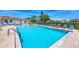 Community pool featuring clear blue water, lounge chairs, and a serene environment for relaxation and enjoyment at 11 Quails Run Blvd # 9, Englewood, FL 34223