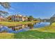 View of the canal, showing the calm waters and manicured lawns at 11 Quails Run Blvd # 9, Englewood, FL 34223