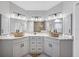 Dual vanity bathroom with marble countertops, modern fixtures and sconces at 11101 Sandrift Ave, Englewood, FL 34224
