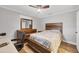 Bedroom features a wooden bed frame, natural light and a desk with a black chair at 11101 Sandrift Ave, Englewood, FL 34224