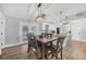 Open dining room with a wooden table and chairs, with views of the pool area at 11101 Sandrift Ave, Englewood, FL 34224