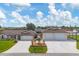 Inviting single-story home featuring a sprawling driveway and manicured lawn with a rear carport at 11101 Sandrift Ave, Englewood, FL 34224