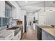 Charming kitchen featuring stainless steel appliances, marble countertops, and a large island at 11101 Sandrift Ave, Englewood, FL 34224