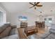 Open-concept living area with stylish furnishings, wood floors, and a view of the dining area at 11101 Sandrift Ave, Englewood, FL 34224