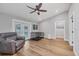 Spacious living room with wood floors, ceiling fan, and access to the pool area at 11101 Sandrift Ave, Englewood, FL 34224
