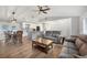 Inviting open-concept living space with wood floors, dining area, and a modern kitchen island at 11101 Sandrift Ave, Englewood, FL 34224