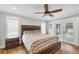 Primary bedroom with wood accents and large windows overlooking the outdoor pool at 11101 Sandrift Ave, Englewood, FL 34224
