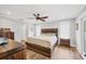 A spacious bedroom featuring a wooden bed frame and lots of natural light at 11101 Sandrift Ave, Englewood, FL 34224