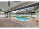 Beautiful pool area with brick pavers, screened enclosure, and lush surroundings at 11101 Sandrift Ave, Englewood, FL 34224