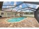 A beautiful private screened-in pool with brick pavers and plenty of space for seating at 11101 Sandrift Ave, Englewood, FL 34224