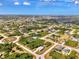 Community aerial view showcasing the landscape and neighborhood layout under bright skies at 115 Australian Dr, Rotonda West, FL 33947