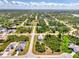 Expansive aerial view of a residential area showcasing neighborhood layout and lush greenery at 115 Australian Dr, Rotonda West, FL 33947