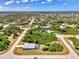 Aerial view of neighborhood featuring lush landscaping and a home with a screened in pool at 115 Australian Dr, Rotonda West, FL 33947
