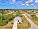 Aerial view of a single-Gathering home with nice front yard landscaping on a sunny day at 115 Australian Dr, Rotonda West, FL 33947