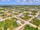 Expansive aerial view of a residential neighborhood featuring well-spaced homes and lush greenery at 115 Australian Dr, Rotonda West, FL 33947