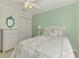 Bedroom featuring a bed with floral quilt, side tables, and double door closets at 115 Australian Dr, Rotonda West, FL 33947