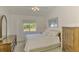 Comfortable bedroom with neutral decor, a window with a view, and classic furnishings at 115 Australian Dr, Rotonda West, FL 33947
