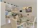 Bright dining area with glass table and wicker chairs, providing an ideal space for Gathering meals and entertaining at 115 Australian Dr, Rotonda West, FL 33947