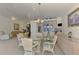 Dining room featuring a glass table, wicker chairs, and seamless access to the living room at 115 Australian Dr, Rotonda West, FL 33947