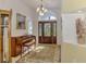 Elegant foyer with decorative rug, chandelier, and an ornate front door at 115 Australian Dr, Rotonda West, FL 33947