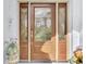 Close-up of an ornate front door with decorative glass panels and sidelights at 115 Australian Dr, Rotonda West, FL 33947