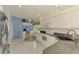 Sunlit kitchen with an eat-in dining area, white appliances, and a modern stainless steel refrigerator at 115 Australian Dr, Rotonda West, FL 33947