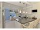 Well-equipped kitchen featuring granite countertops, white cabinetry, and ample seating at the breakfast bar at 115 Australian Dr, Rotonda West, FL 33947