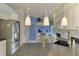 Well-lit kitchen features granite countertops, stainless steel appliances, and a cozy breakfast nook area at 115 Australian Dr, Rotonda West, FL 33947