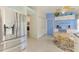 Bright kitchen area with modern stainless steel refrigerator, eat-in kitchen, and bright blue painted wall at 115 Australian Dr, Rotonda West, FL 33947