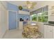 Bright eat-in kitchen features a breakfast nook with lovely views of the landscaped exterior at 115 Australian Dr, Rotonda West, FL 33947