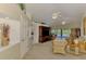 Bright living room with vaulted ceilings, neutral paint, and wicker furniture that offers a comfortable space to relax at 115 Australian Dr, Rotonda West, FL 33947