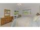 Bright bedroom boasts sliders to the lanai, plus bamboo furniture and serene decor at 115 Australian Dr, Rotonda West, FL 33947