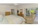 Spacious bedroom with lanai access, bamboo furniture, and a comfortable seating area at 115 Australian Dr, Rotonda West, FL 33947