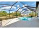 Backyard pool surrounded by a screened-in enclosure, providing privacy and a serene atmosphere at 115 Australian Dr, Rotonda West, FL 33947