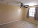 Neutral bedroom boasts wood-look floors, ceiling fan, and natural light at 1160 Sharlo Cir, Englewood, FL 34224