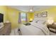 Comfortable bedroom boasts a ceiling fan, window views, and stylish decor at 1160 Sharlo Cir, Englewood, FL 34224