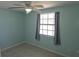 Calming bedroom featuring a ceiling fan, neutral decor, and natural light at 1160 Sharlo Cir, Englewood, FL 34224