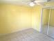 Simple bedroom featuring ceiling fan, tile floor, and sliding door closet at 1160 Sharlo Cir, Englewood, FL 34224