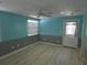 A bedroom features a ceiling fan, wood floors, a door to the backyard, and windows at 1160 Sharlo Cir, Englewood, FL 34224