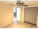 Neutral bedroom boasts wood-look floors, ceiling fan, and modern finishes at 1160 Sharlo Cir, Englewood, FL 34224