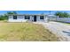 Charming single-story home with light blue exterior, well-maintained lawn, and convenient carport at 1160 Sharlo Cir, Englewood, FL 34224