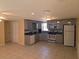 Bright kitchen featuring gray cabinets, granite countertops, and stainless steel appliances at 1160 Sharlo Cir, Englewood, FL 34224