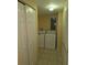A laundry room with a washer and dryer, tiled floor, and bi-fold closet doors at 1160 Sharlo Cir, Englewood, FL 34224