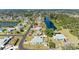 Scenic aerial view showcases neighborhood homes along a waterfront canal, with lush landscapes and clear blue skies at 1278 Lincoln Dr, Englewood, FL 34224