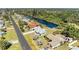 Aerial view of a home near a canal, featuring a private dock, lush landscaping, and neighborhood streets at 1278 Lincoln Dr, Englewood, FL 34224